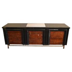 a black and brown cabinet with three drawers on one side, two doors at the other