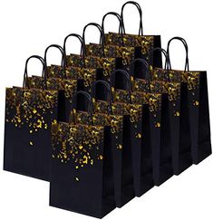 black paper bags with gold confetti sprinkles are lined up against a white background