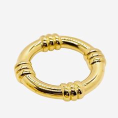 a gold colored metal ring with four balls on the end and one ball in the middle