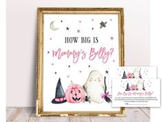 a sign that says how big is mommy's belly? and two little witches