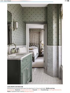 the bathroom is decorated in green and white with polka dots on the walls, along with an open door leading to another room