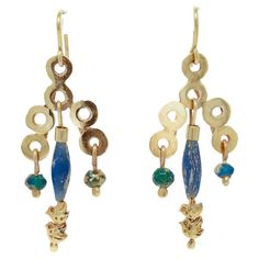 A fine pair of Etruscan Revival style earrings.  By the New York City Modernist female goldsmith Resia Schor.   In 14k gold.  Comprised of hand-built 14k gold loops supporting drops with ancient glass beads and double bird terminals. Each set with handmade ear wires.  Designed with stylistic elements of the work of Resia's husband, Ilya Schor, Cubism, and Brutalism. Incorporating these elements in addition to a strong nod to the design of ancient jewelry of the Mediterranean, Resia Schor's work Traditional Handmade 14k Gold Earrings, Artisan Yellow Gold Earrings, Unique Yellow Gold Dangle Earrings, Artisan Gold Earrings With Dangling Beads, Sterling Silver Gold Earrings With Dangling Beads, Gold Sterling Silver Earrings With Dangling Beads, Unique Yellow Gold Pierced Earrings, Yellow Gold Byzantine Drop Earrings, Bead Drop Earrings