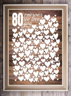 a framed paper cut out of hearts with the words 80 reasones we love you