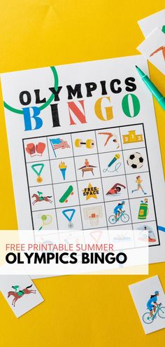 an olympic bingo game on a yellow table with crayons