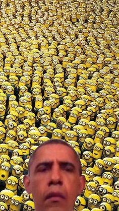 a man standing in front of a large group of minion faces with one eye open