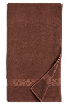 a brown towel folded on top of a white background