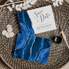 a blue and white wedding suite on top of a wicker table