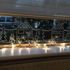 the window is decorated with christmas lights