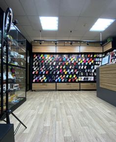 the inside of a store with wooden floors and glass cases filled with items on display