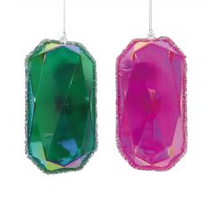 two colorful ornaments hanging from strings on a white background in the shape of rectangles