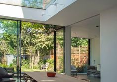 the dining room table is surrounded by glass walls