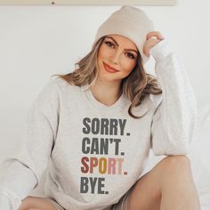 Whether you're a sport-loving Mom or Dad, or a passionate participant, our "SORRY. CAN'T. SPORT. BYE." sweatshirt is the ideal addition to your wardrobe. Made with a cozy cotton polyester blend, it lets you express your devotion to sports while staying snug and stylish. A unisex style in a medium-heavy blend that is 50% cotton, 50% polyester. This sweatshirt is a classic crewneck style. The collar is a ribbed knit, which retains its shape even after washing. These sweaters are free of itchy side Sports Sweater, Sports Lover Gifts, Sport Mom, Sports Mom Shirts, Photo Care, Funny Sports, Sport Sweater, Crewneck Style, Sports Lover