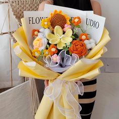 a woman holding a bouquet of flowers in her hands