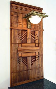 a wooden door with a light on top of it