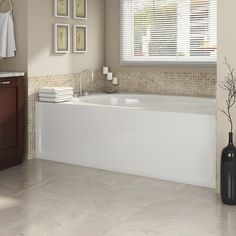 a bathroom with a tub, toilet and sink in it's centerpieces