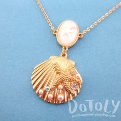 - Description - Details Accessorize like a mermaid would with this beautiful necklace featuring a seashell pendant covered in starfishes, pearls and rhinestones in gold! Store FAQ | Shipping Info | Returns & Exchanges Size: The seashell pendant measures 3 cm tall by 3.5 cm wide and hangs on a 32 inch long chain that can be adjusted with a lobster clasp! Material: Gold Plated Tin Alloy, Pearl Beads, Rhinestones Animal Jewelry by DOTOLY Gold Starfish Shell Necklace, Gold Seashell Necklace, Sunrise Shell, Sea Life Jewelry, Gold Mermaid, Life Jewelry, Seashell Pendants, Marcasite Jewelry, Mermaid Jewelry