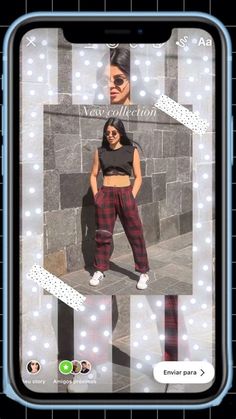 a woman in plaid pants and crop top standing next to a wall with lights on it