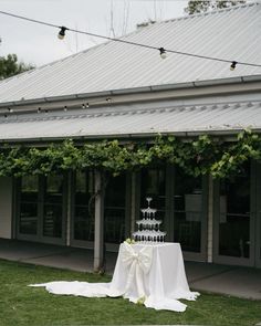 a table with a cake on it in front of a building