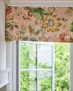 an open window with a flowered valance on it