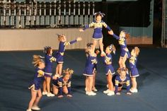 a group of cheerleaders standing on top of each other