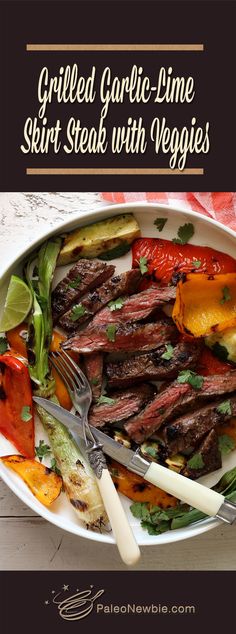 grilled garlic - lime skirt steak with veggies on a white platter