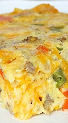 an omelet with meat and vegetables on it is sitting on a white plate