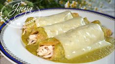 two enchiladas on a white plate with green sauce