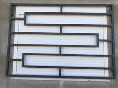 an image of a window that is on the side of a building with bars in it