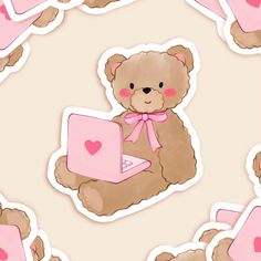 a brown teddy bear sitting on top of a laptop computer next to pink heart stickers