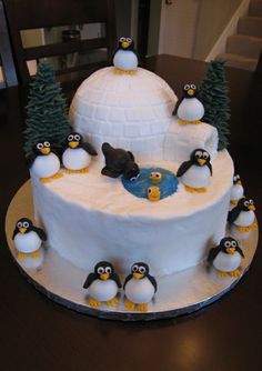 there is a cake with penguins on it