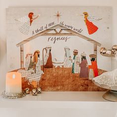 a nativity scene is displayed on a mantle