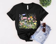 Boho Wildflower Cottagecore Shirt | Gift For Her | Nature Lover Shirt | Plant Shirts| Floral Shirt | Gift For Women| Gardening Tshirt | Boho Tee ** HOW TO ORDER 1. Check our photos for sizing and color options. 2. Select your size and color from the drop-down menus. 3. Click "ADD TO CART" to add the shirt to your cart. 4. Click "PROCEED TO CHECKOUT" to purchase your shirt. ** PRODUCTION TIME: 1-3 days (Usually 2 days) ** SHIPPING TIME: 2-5 days (Usually 3 days) ** DETAILS: The garment-dyed t-shirt by Bella Canvas is a customizable tee made entirely from 100% ring-spun cotton. ** SIZING : - Please refer to size chart on the listing photos for a detailed sizing chart with measurements. - Unisex sizing. - If you are seeking an oversize look be sure to order 1 to 2 sizes up from your regular s Spring Gardening Short Sleeve Tops, Short Sleeve Shirt For Gardening In Spring, Relaxed Fit T-shirt For Gardening In Spring, Spring Short Sleeve T-shirt For Gardening, Spring Crew Neck T-shirt For Outdoor, Casual T-shirt For Gardening In Spring, Casual Spring T-shirt For Gardening, Gardening Tshirt, Plant Shirts