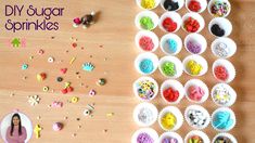 a wooden table topped with lots of cupcakes