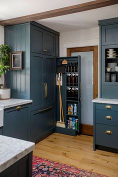 a kitchen with blue cabinets and white counter tops