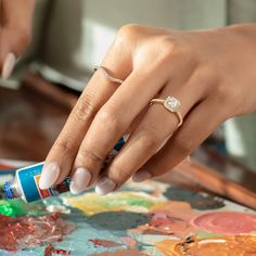 a close up of a person's hand with a ring on it