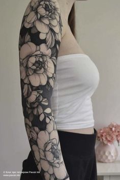 a woman with black and white flowers on her arm