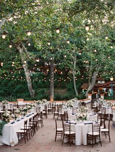 an outdoor wedding venue with tables and chairs