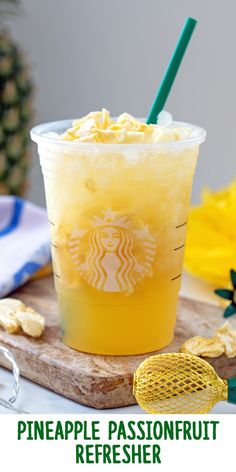 the pineapple passionfruit refresher is served in a plastic cup with a straw