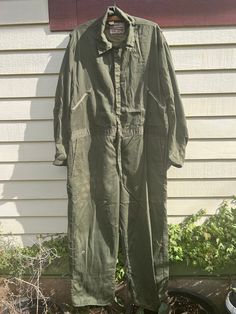 "A great pair of Walls brand Blizzard Proof dark greenish olive coveralls. Snap and zipper closures. Lots of overall wear, including: scuffing, places of loose seams, broken zipper on back pocket and some small stains and holes. Still completely wearable with or without those small mends. This is a piece that shows it's history. Lined in olive drab nylon with inside cuffs. It's not bulky but it will keep you warm. The outer shell is a cotton poly blend. Tagged XL MEASURED FLAT: Shoulder: 20\" Chest: 24\" Waist: 23\" Hip: 24\" Inseam: 28\" Outseam: 58\" Sleeve: 22\" Best fit: Unisex XL. Please measure against yourself for best fit." Green Boiler Suit Outfit, Vintage Green Cotton Jumpsuits And Rompers, Short Sleeve Coveralls, Military Style Green Overalls With Pockets, Military Green Overalls With Pockets, Men’s Coveralls, Mechanic Coveralls, Broken Zipper, Edwardian Dress