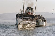 a large boat with lots of people on it in the water