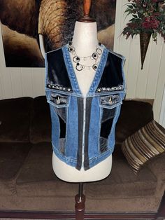 a mannequin wearing a blue jean vest