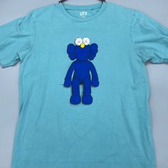 New Without Tags Is The Unique Kaws X Uniqlo Tshirt Unisex Shirt Material: Cotton Blend, Very Soft Size: Medium Measurements: Upon Request Condition: No Flaws, Never Worn If This Is Your First Time On Poshmark Make Sure You Use My Code Liyahchiqcloset To Save $10 Light Blue Cotton Streetwear Tops, Light Blue Short Sleeve Shirt For Streetwear, Blue Short Sleeve Shirt With Screen Print, Blue Crew Neck Shirt With Screen Print, Casual Light Blue Screen Print T-shirt, Blue Cotton Graphic Tee Shirt, Blue Cotton Graphic Tee, Casual Blue Screen Print Top, Casual Blue Top With Screen Print