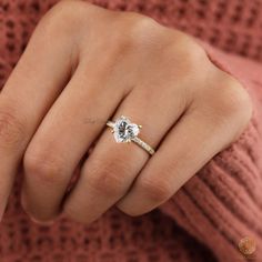 a woman's hand with a diamond ring on it