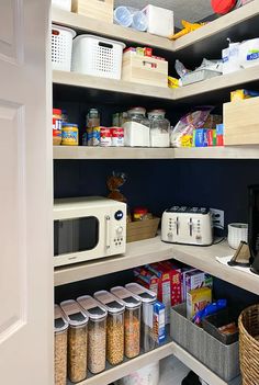 an organized pantry with lots of food and containers on the shelves, along with other items