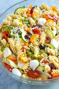 a bowl filled with pasta salad on top of a table