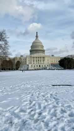 the u s capitol building in washington d c is covered in snow on a winter day