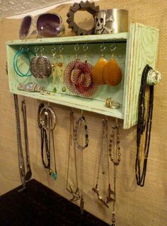 a shelf with lots of jewelry hanging on it