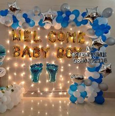 baby shower decorations and balloons are displayed in front of a backdrop that reads,'welcome baby boy '