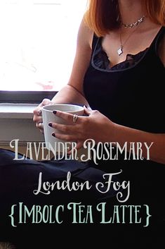 a woman sitting on the windowsill holding a cup