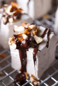 some kind of cake that is sitting on a rack with chocolate sauce drizzled over it